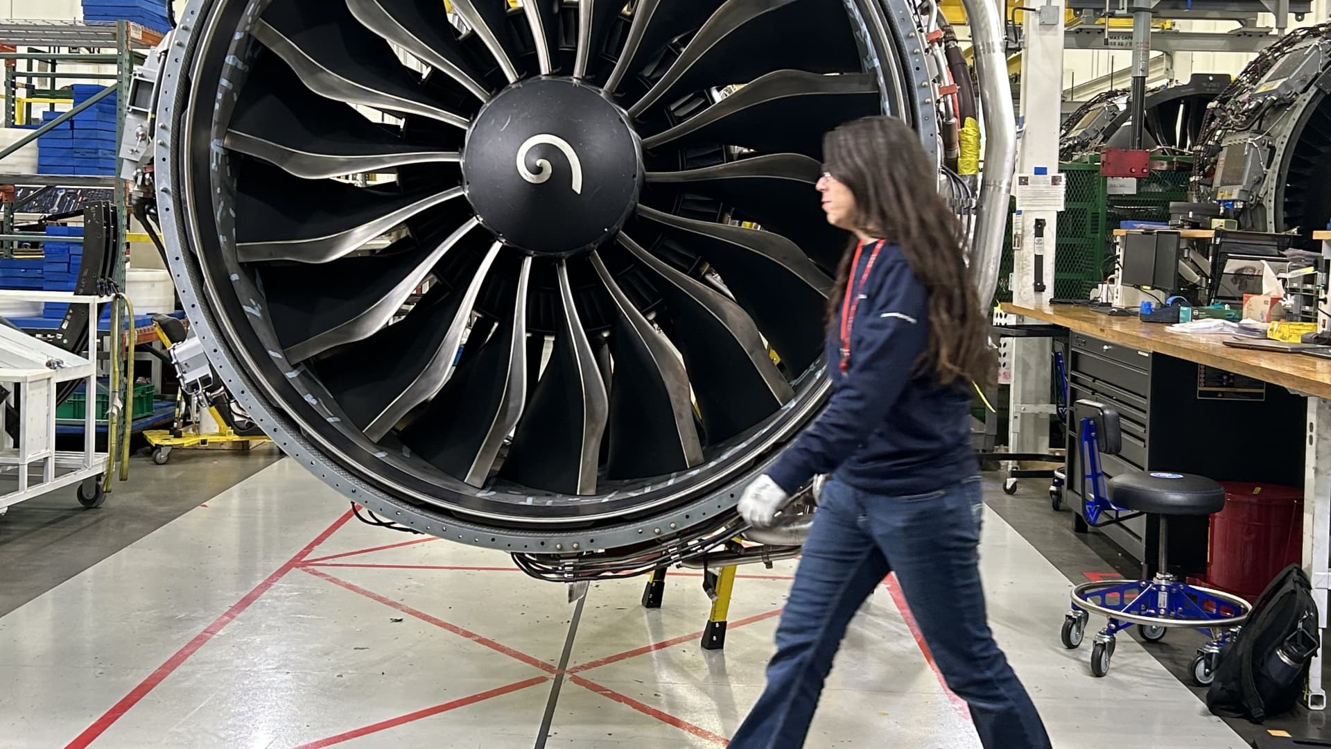 GE Aerospace jet engine on a commercial aircraft wing with a blue sky background