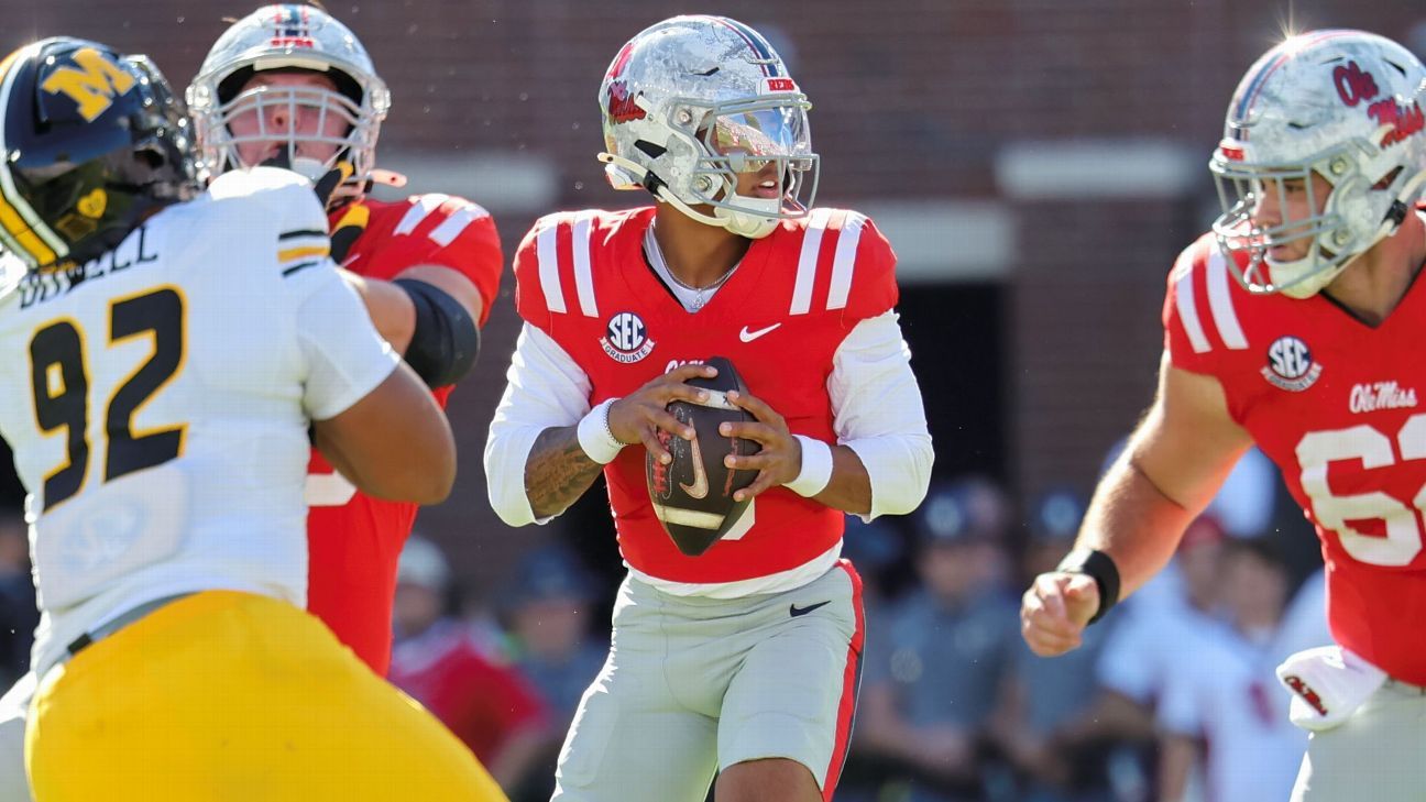 College football players lined up on the field during a high-stakes regular season game