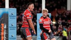 Gloucester and Bath rugby players contest possession during the Gallagher Premiership derby at Kingsholm Stadium.