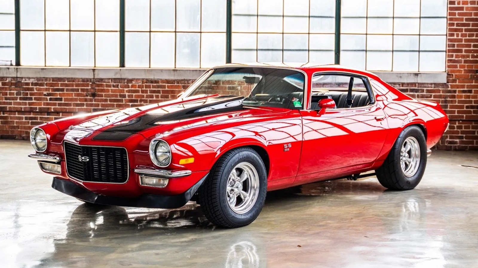 Red 1970 Chevrolet Camaro with a black hood treatment and American Racing wheels