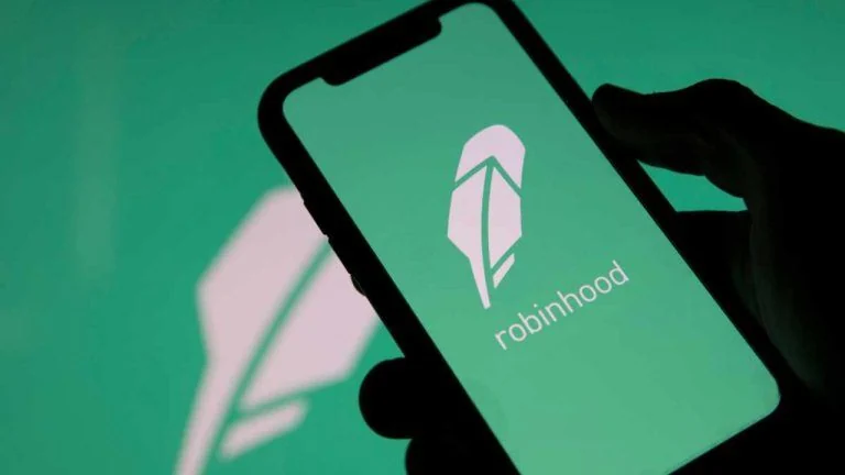 Robinhood Markets logo on a smartphone screen with a stock chart showing mixed quarterly performance in the background