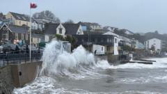 Storm waves crashing against a harbour wall as Storm Boelo sweeps across the UK coastline