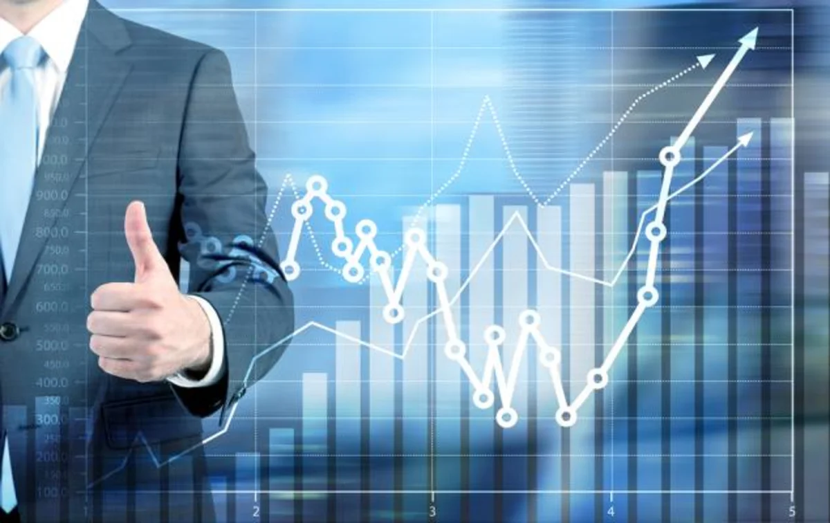 A financial trading floor monitor displaying stock market charts and ticker data amid market fluctuations.