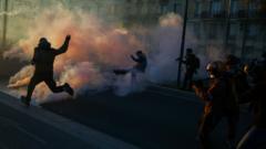 Police and demonstrators clash on a street during nationwide cost-of-living protests in Paris, France.