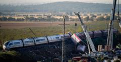 Emergency personnel and investigators gather near derailed high-speed train carriages following a fatal rail collision in Toledo province, Spain.