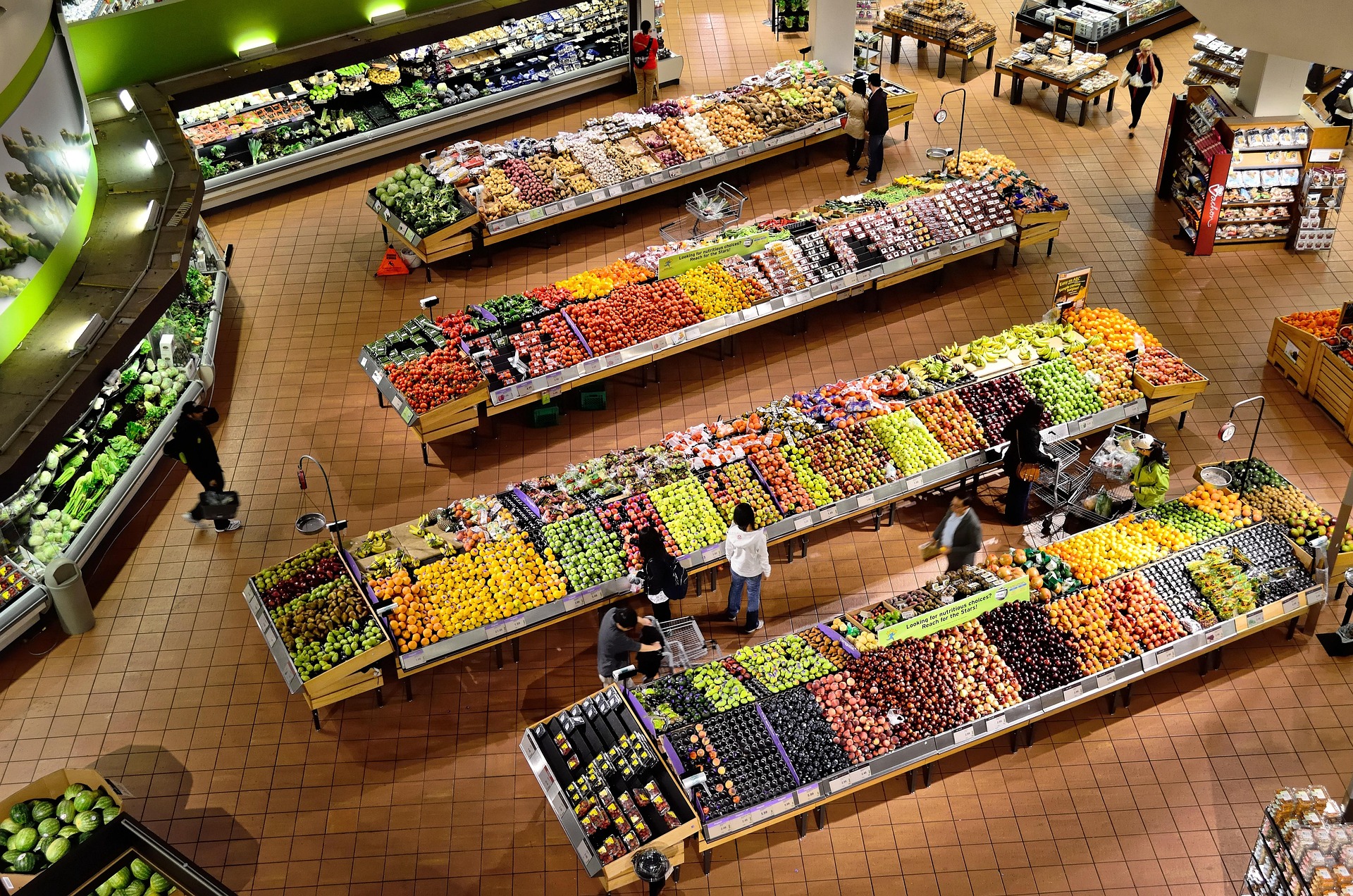 Kroger supermarket storefront with stock ticker display showing KR share price movement
