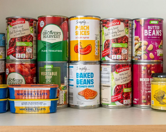 Tinned food and bottled water stored alongside a torch and wind-up radio