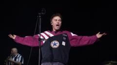 Sam Fender performing on stage