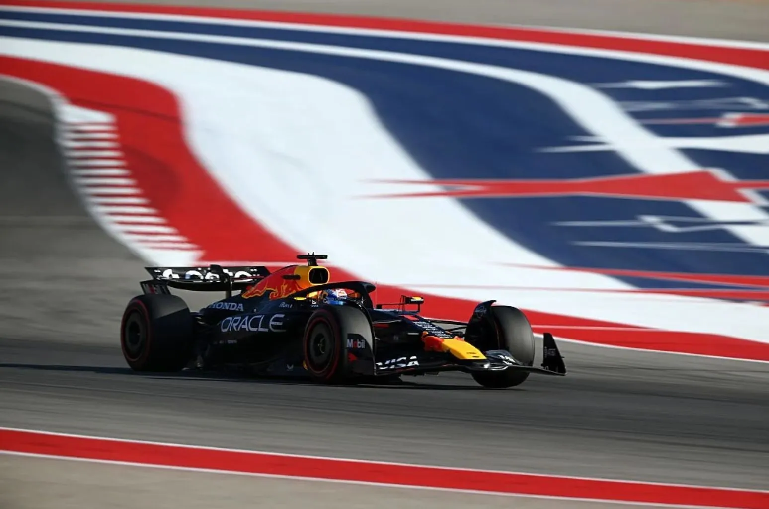Formula 1 cars navigating the uphill Turn 1 at Circuit of the Americas during the United States Grand Prix.