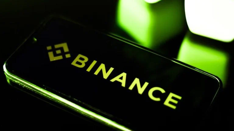 Binance logo displayed on a digital screen alongside cybersecurity data visualizations.