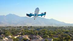 A delivery drone hovering above a residential street, its rotors visible against a clear sky