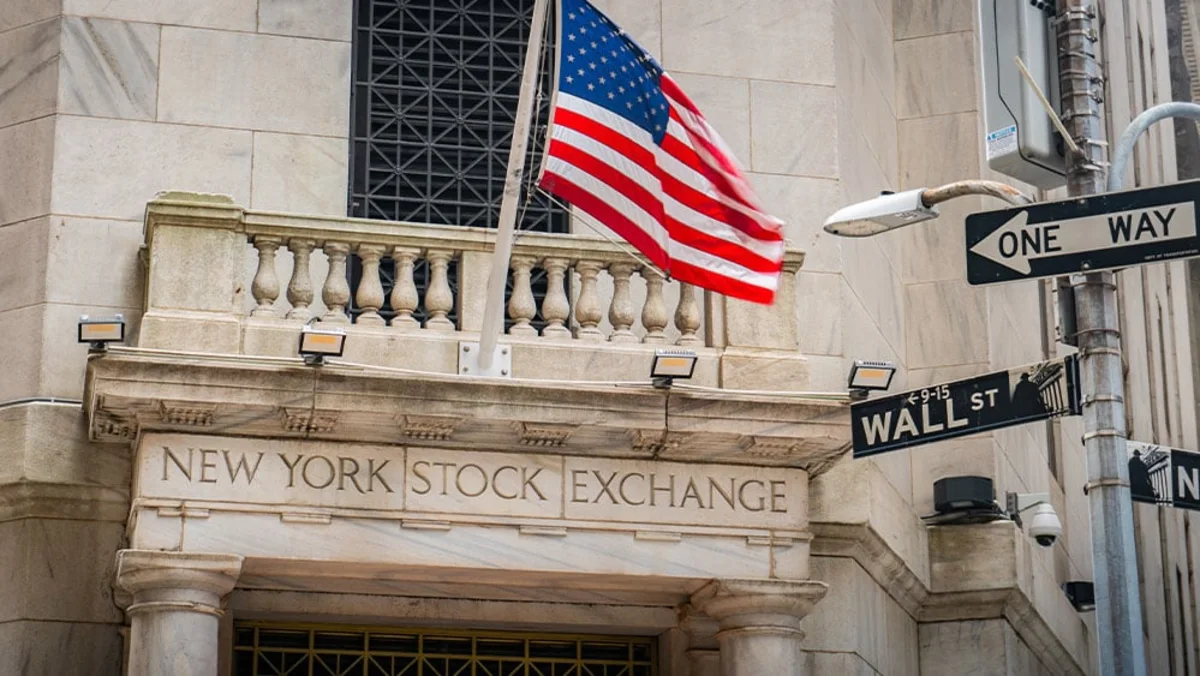 Financial district stock ticker boards reflecting market declines and rising energy commodity charts.