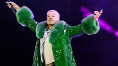 Macklemore performing onstage with a microphone