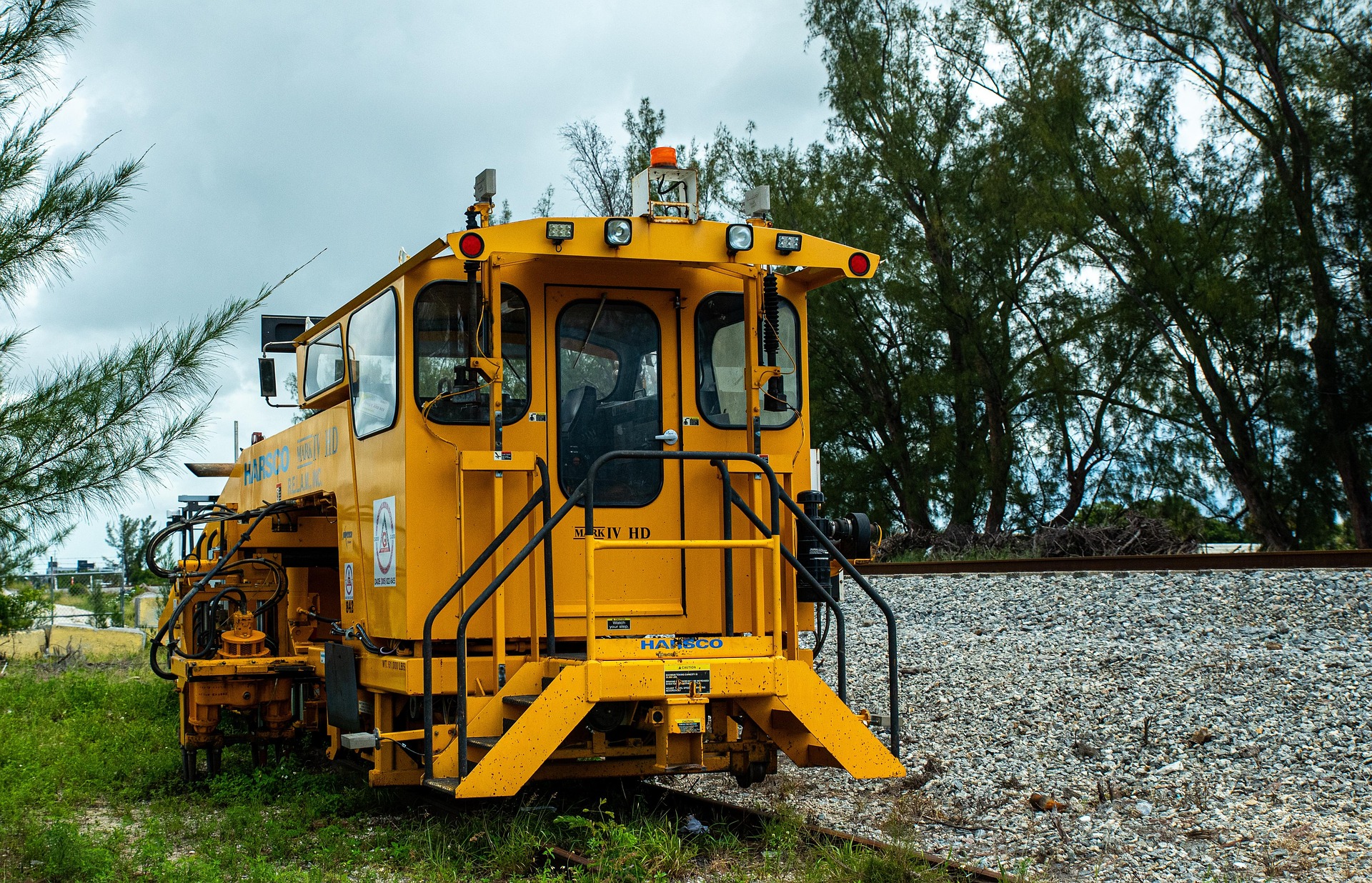 A CSX freight train traveling along commercial railway tracks.