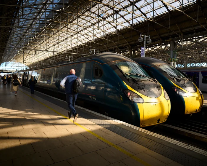 An Avanti West Coast passenger train parked at a station platform in the United Kingdom