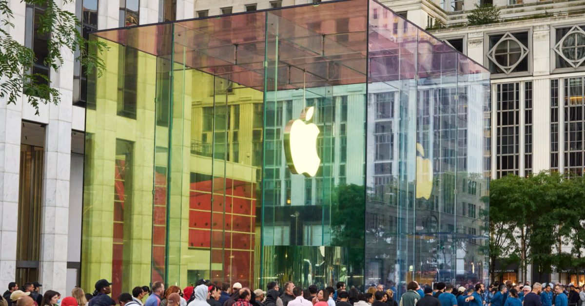 Large rectangular installations covered in black fabric and white wrapping outside Apple Fifth Avenue’s glass cube entrance