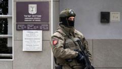 Police vehicles and officers outside the Israeli embassy in Belgrade, Serbia, following a knife attack in the early hours of Wednesday morning