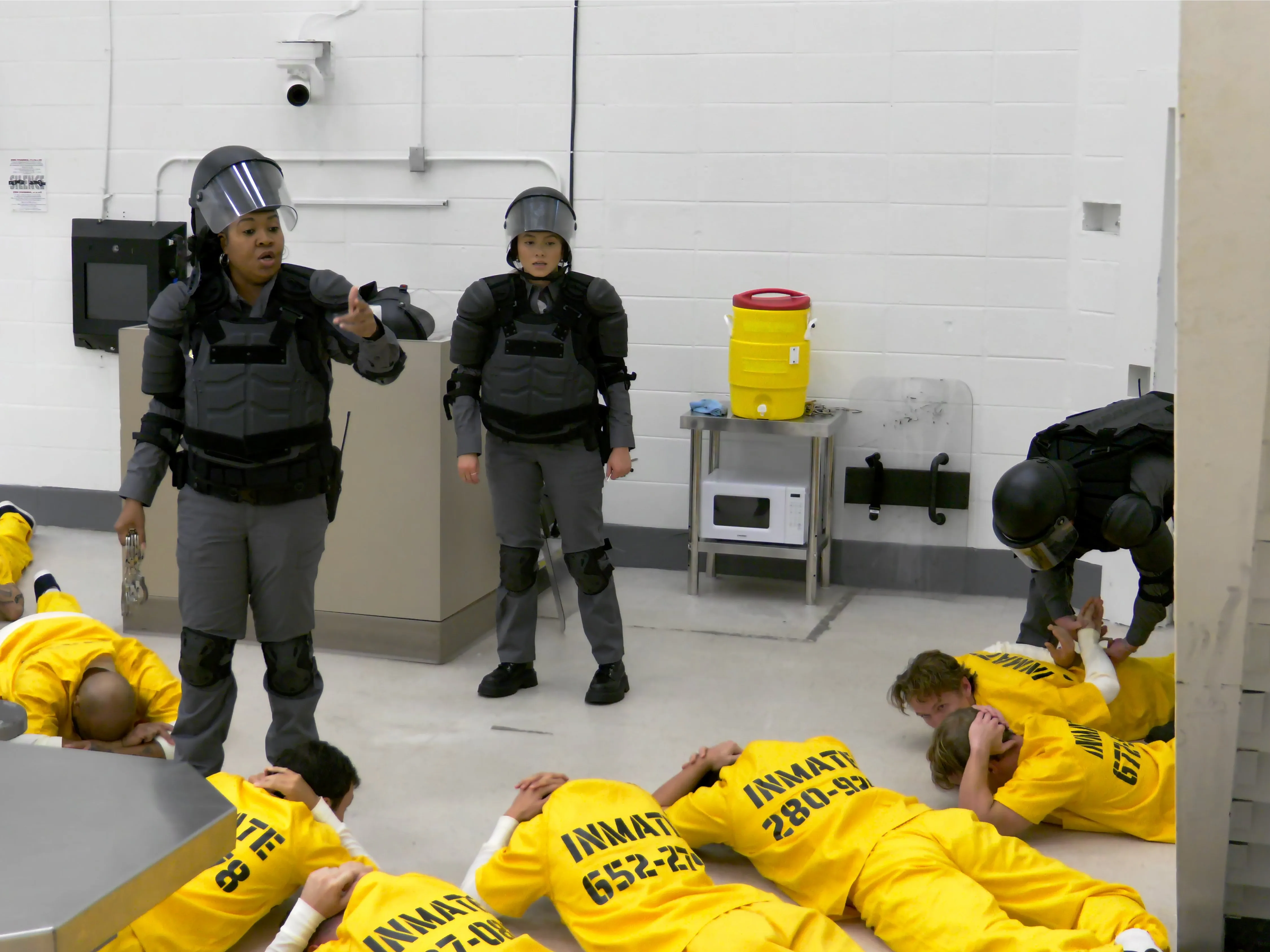 Participants in yellow uniforms inside the prison setting of Netflix’s The New Stanford Prison Experiment